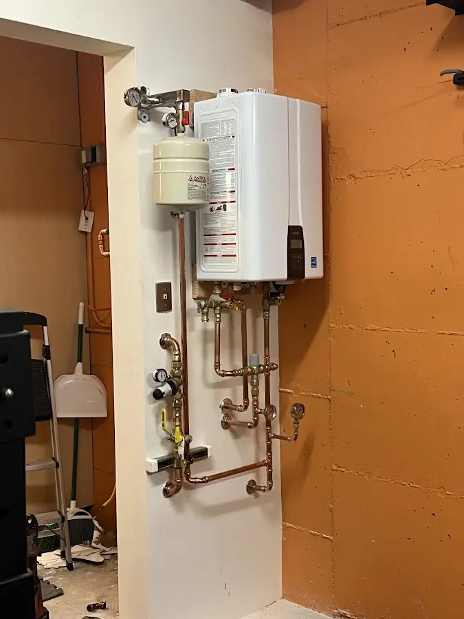 Plumbing technician inspecting water heater connections in Skippers Corner